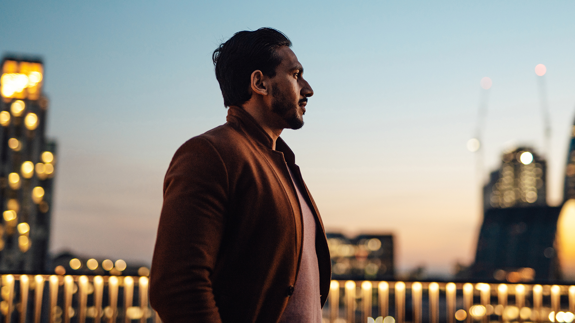 Businessman looking over city at rooftop