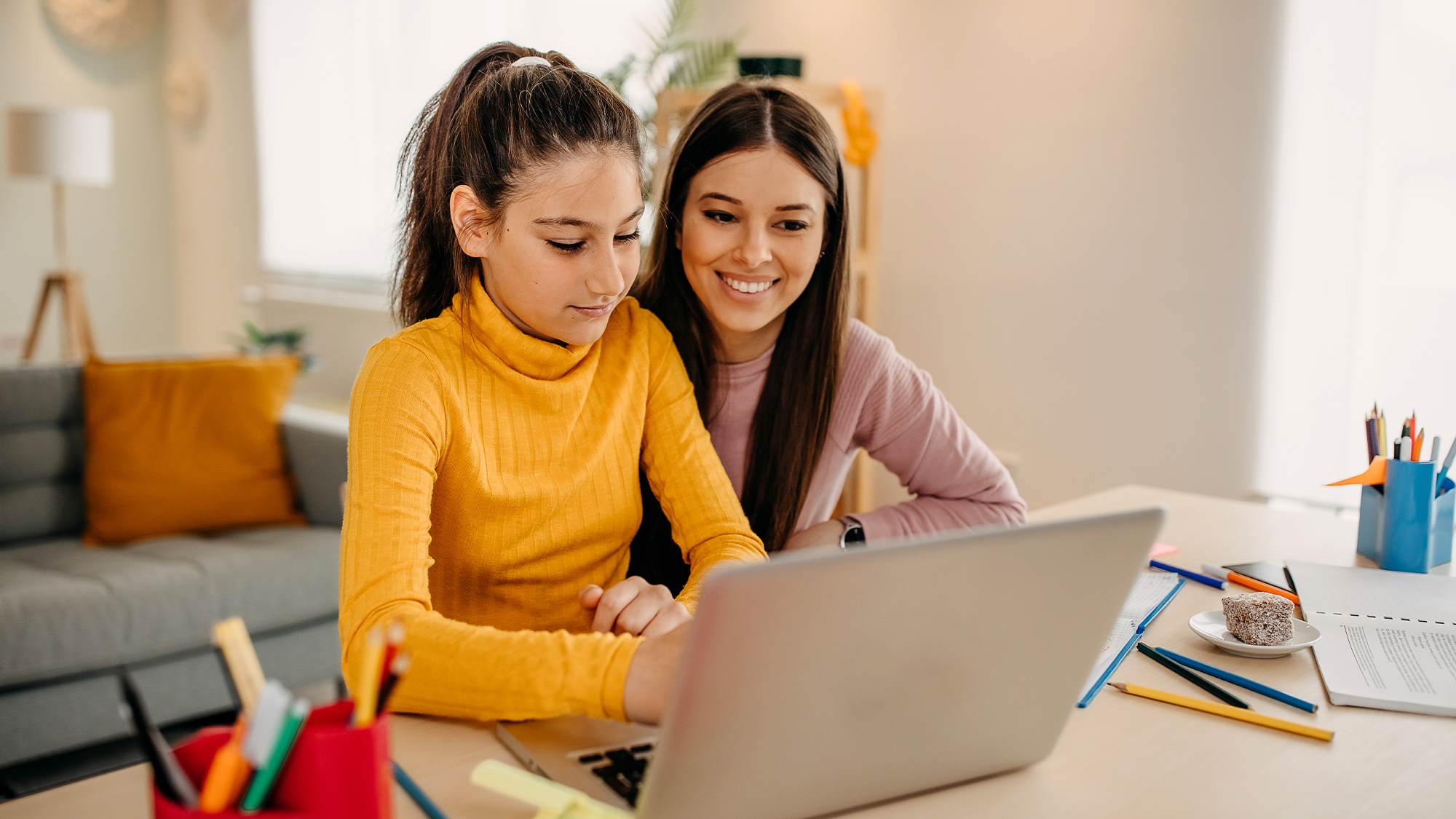 Mother is helping daughter with homework